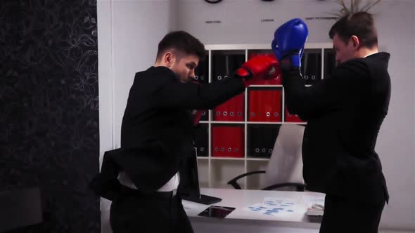 Boss and Employee Boxing in Office Room