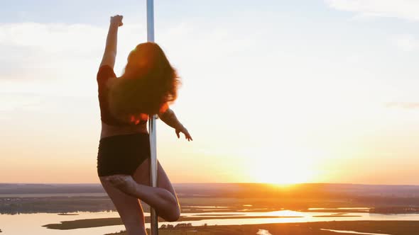 Pole Dance on Sunset - Young Woman Dancing By the Pole