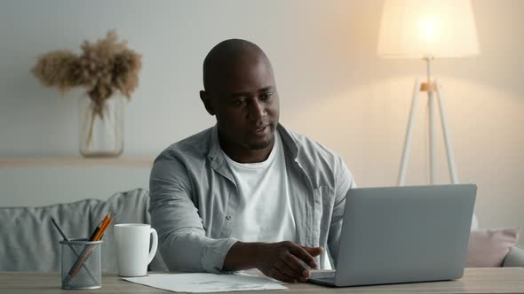 Black Man Having Video Call At Laptop Gesturing ThumbsUp Indoors