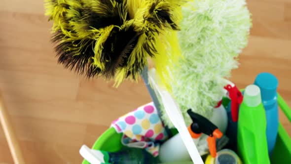 Various housekeeping supplies in a bucket