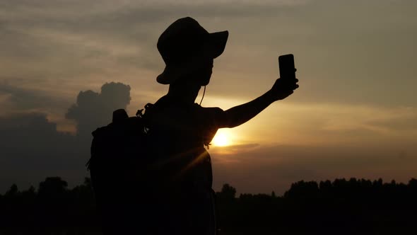 Hiker man holding smartphone and video call to friend