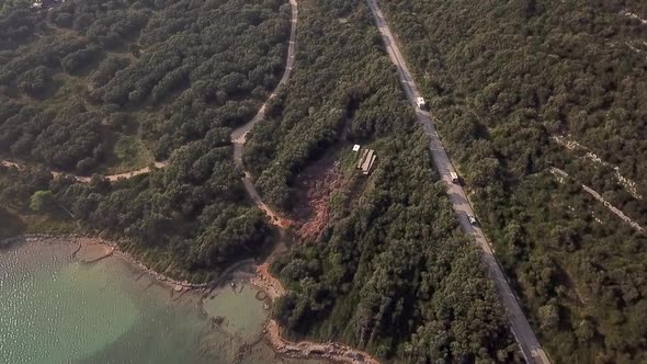 Aerial view of recreational vehicle riding at coastal road, Losinj, Croatia.
