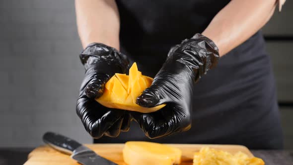 Tasty Juicy Ripe Mango Cut in Cubes with Knifebeing Opened Inside Out. Tropical Fresh Fruit Sliced