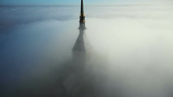 Drone Flying Very Close To Epic Golden Castle Spire Top of Mont Saint Michel, Iconic Cloudy Fortress