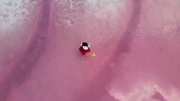 Happy Laughing Girl in Red Skirt Runs on Shallow Water Along White Salty Shore