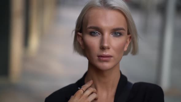 Portrait of Androgynous Model in City at Daytime, Person Is Looking at Camera