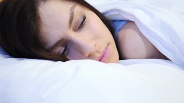 Close Up of Young Woman Trying to Sleep in Bed at Night
