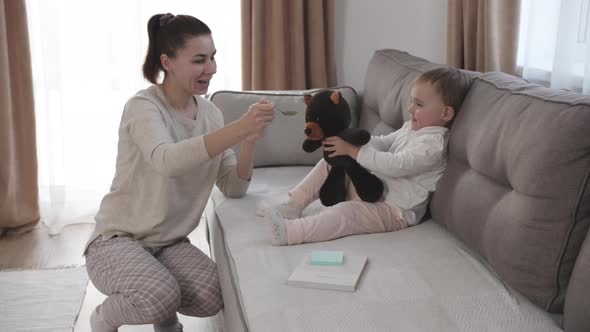 Woman Feeding Child with Spoon