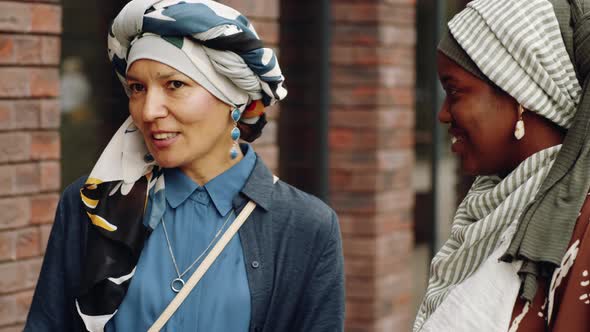 Happy Female Friends Talking Outside