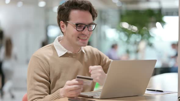 Online Shopping Success on Laptop By Creative Young Man
