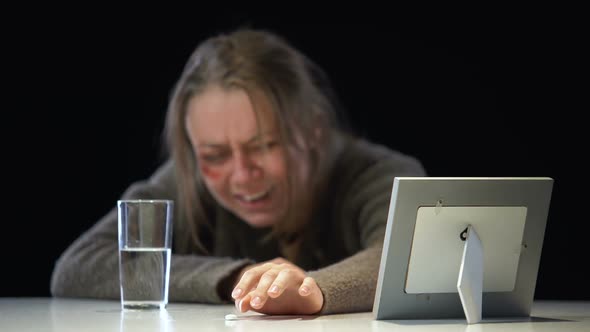 Depressed Crying Lady Looking at Photo Taking Antidepressant, Violence Victim