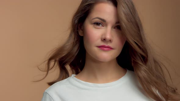 Monochrome Natural Makeup Look Caucasian Woman in Studio with Brunette Wavy Hair Blowing