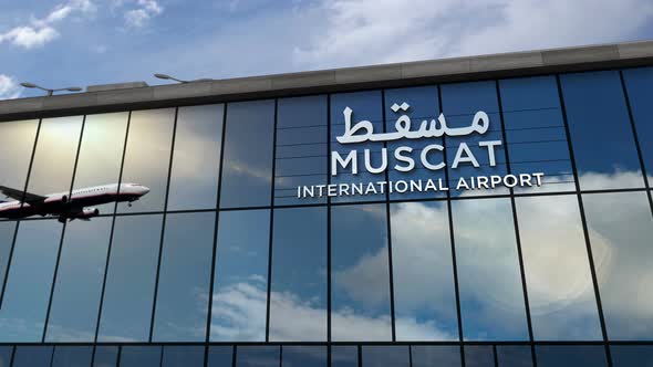 Airplane landing at Muscat Oman airport mirrored in terminal