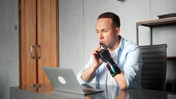 Thoughtful man company worker with bio hand high tech prothesis