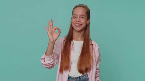 Lovely Girl Child Looking Approvingly at Camera Showing Ok Gesture Like Sign Positive Approve Good