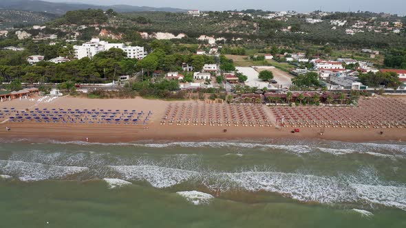 Aerial view of amazing beach with colorful umbrellas and turquoise sea