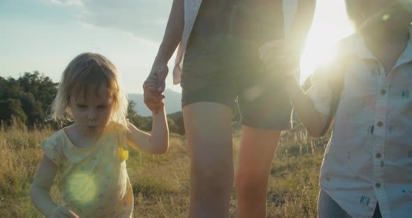 Mother Hold Children Hands and Walk on Beautiful Landscape on Travel Adventure