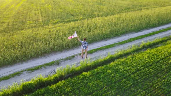 Man Holds Waving American Flag