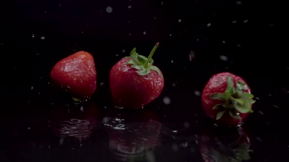 Strawberry Slow Motion Closeup Falling in Water with Splash Droplets