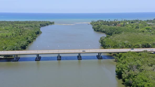 Bridge crossing the Soco river close to the river mouth, aerial fly over