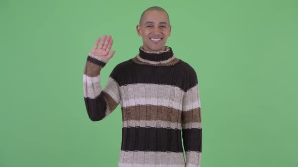 Handsome Bald Multi Ethnic Man Waving Hand Ready for Winter