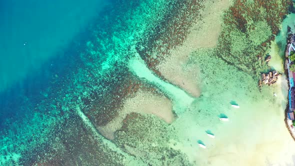 human-made cuts in the coral reef serve as a passage for the boats to access tropical beach. Vertica