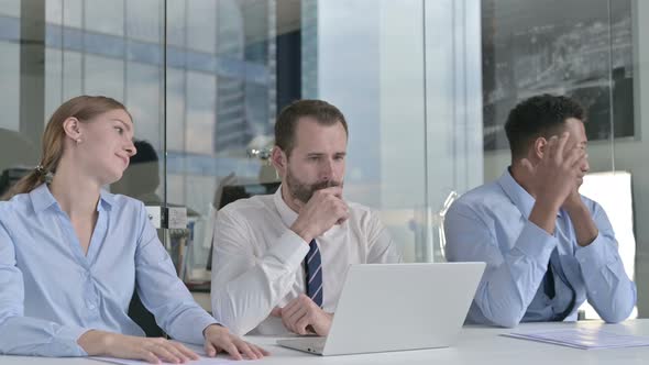 Business People Get Disappointed While Using Laptop on Office Table 