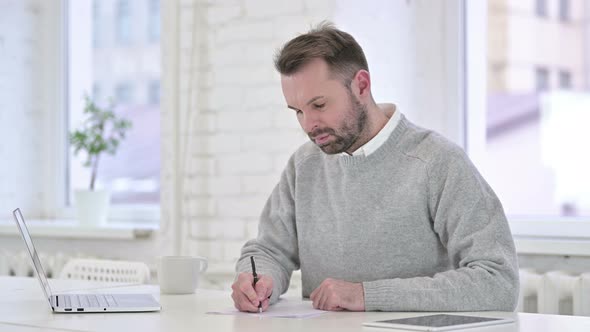 Creative Man Writing on Paper at Work, Paperwork