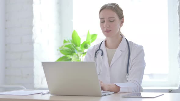 Lady Doctor Smiling at Camera While Sitting in Clinic