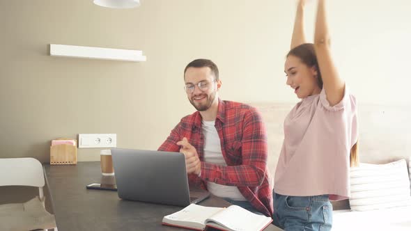 Happy Couple Getting Good News, Lovely Woman Raises Hands Up in Win Gesture