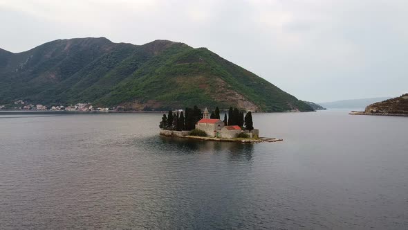 A Little Island with a Small Old Church and Trees in the Sea