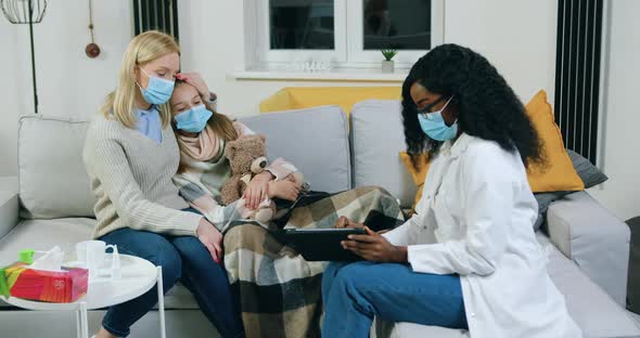 Female Doctor Visiting Sick Teen Patient which is Under Mother's Supervision at Home