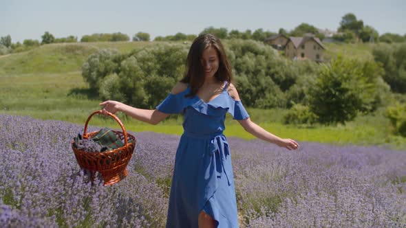 Joyful Woman with Arms Outstretched Walks in Field