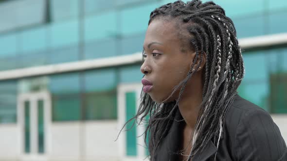 pensive lonely black businesswoman thinking alone in the city-slow motion