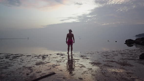 Back View of Man Traveler Enjoying Seaside Colorful Dramatic Sunset Cloudy Sky Standing By the Sea