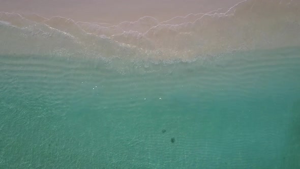 Drone aerial travel of coastline beach break by blue water and sand background