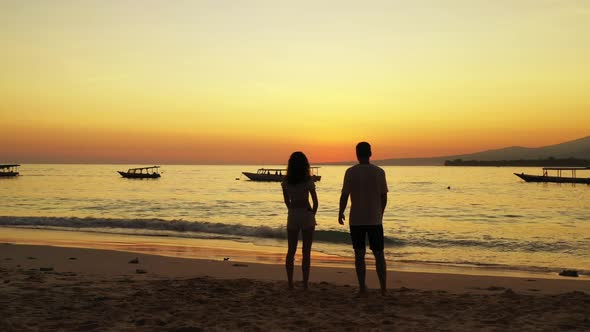 Romantic couple engaged on perfect lagoon beach break by blue green water with white sand background