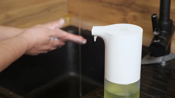 Woman's Hands Apply Soap with a Contactless Dispenser and Wash Closeup
