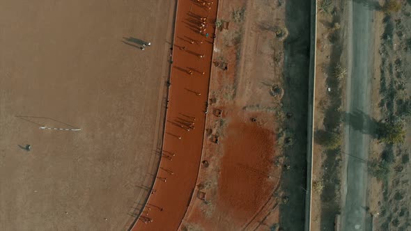 An ascending shot of children running on a clay circuit