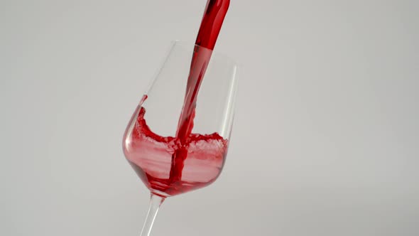 Slow Motion of Pouring Wine in Tilted Glass at 1000 Fps White Background