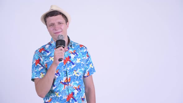 Happy Young Handsome Tourist Man As Host Using Microphone