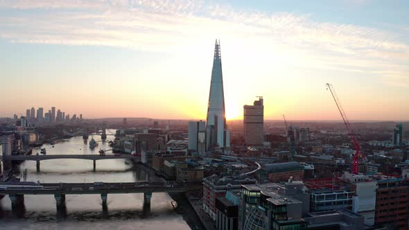 Descending Aerial drone shot of the shard thames river southwark at sunrise