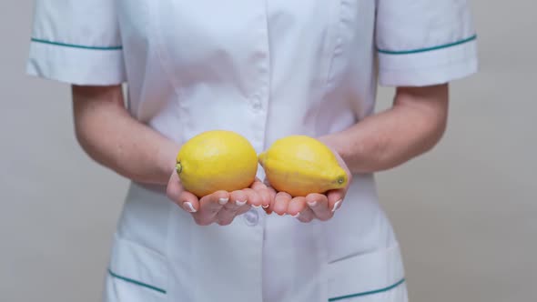 Nutritionist Doctor Healthy Lifestyle Concept - Holding Organic Lemon Fruit