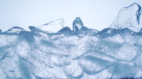 Pouring soda water with ice and bubbles in the glass. 