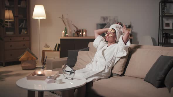 Woman Relaxing With Banana Slices On Face