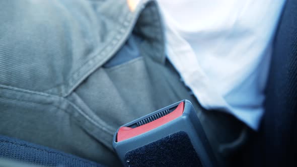 Man Unbuckles His Seat Belt and Gets Out of the Car