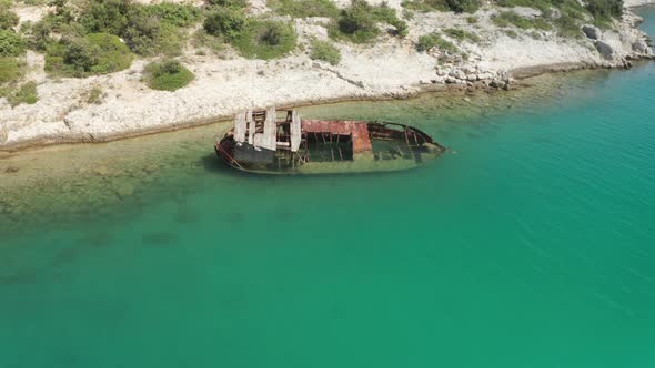 Super wide shot of a ship wreck stranded on a beautiful hidden beach in Croatia. Parallax shot of th