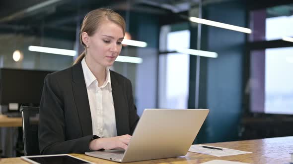 Young Businesswoman Saying No By Shaking Head in Office 