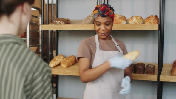 Beautiful Black Woman Selling Fresh Bread in Bakery