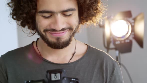 Photographer looking at photos on digital camera